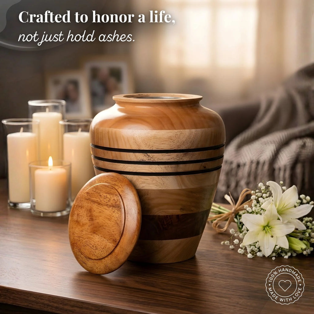 Wooden urn on a table with candles and flowers, with text 'Crafted to honor a life, not just hold ashes.'