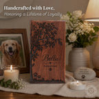 Wooden plaque with engraved tree and 'Bella' on a table with candles and flowers.