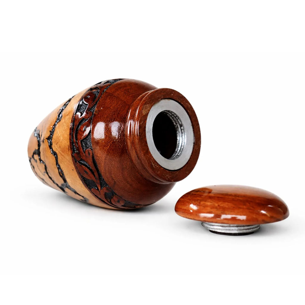 Wooden urn with silver base on a white background