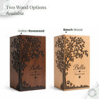Two wooden urns with engraved trees and 'Bella Forever Loved' text, labeled 'Indian Rosewood' and 'Beech Wood'.