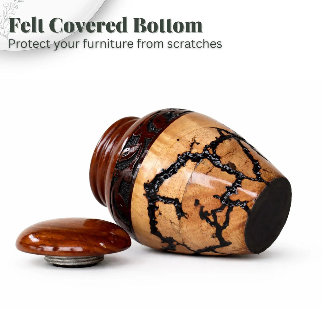 Wooden furniture leg with felt-covered bottom on a white background